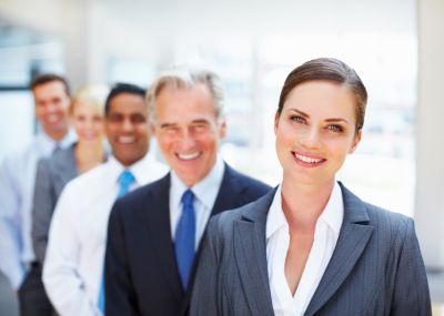 Employees discussing group health insurance coverage in an office setting.